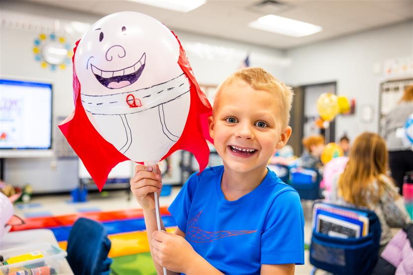 Students participate in a balloon parade